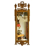 Gilded mirror with urn & ribbon top