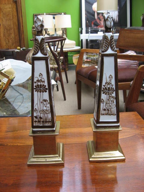 Elegant obelisks with beautiful brown hand painted detail and brass pedestals.