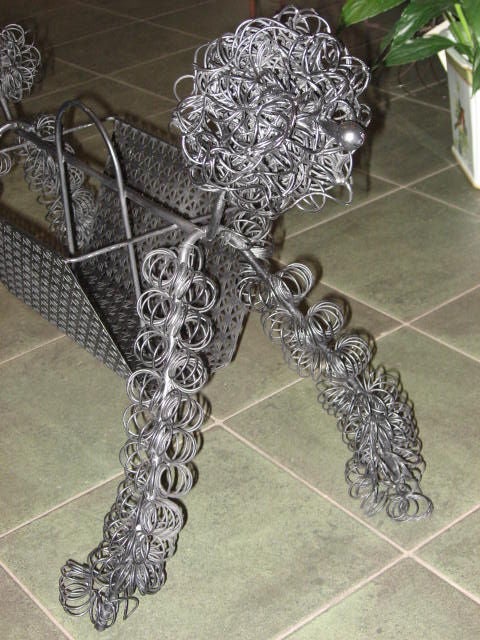 Fun sculptural poodle magazine rack. Black finish.