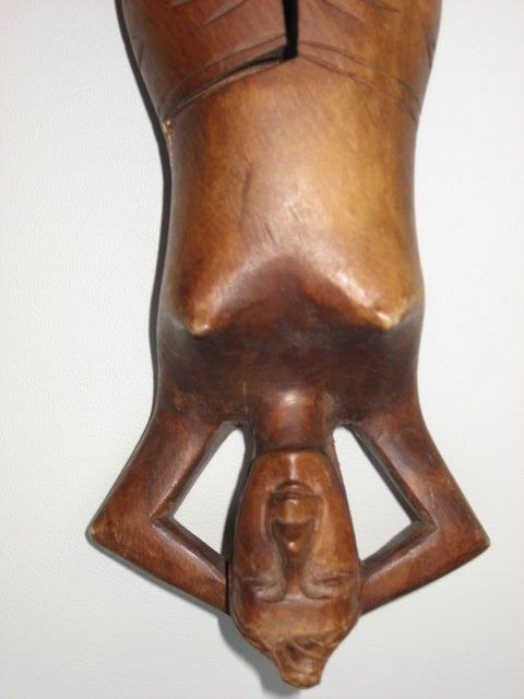 Hand carved wooden nutcracker is in the shape of a woman.