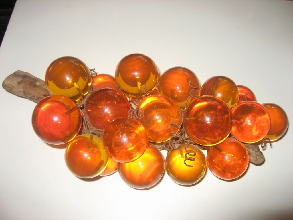Amber Lucite grapes make a spectacular accessory for any space. A second set of Amber Colored Lucite grapes on a vine is available. Each set sold separately.