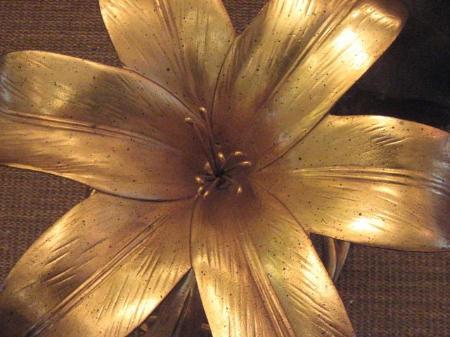 The lines of Art Nouveau combine with the surrealism of the 60's to create an eye catching piece with a sculptural element. Tole bases are constructed of metal and gilded then topped with an 3/4 inch piece of circular glass. Price is per table.