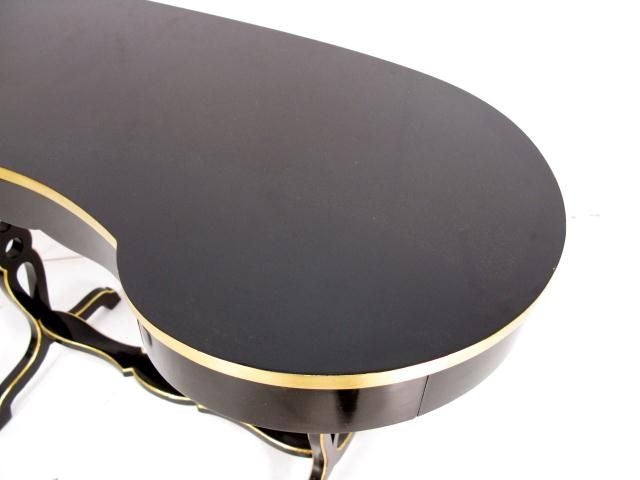 Amazingly unique and versatile black lacquer table with small drawer. Beautiful curved legs and gold detailing.