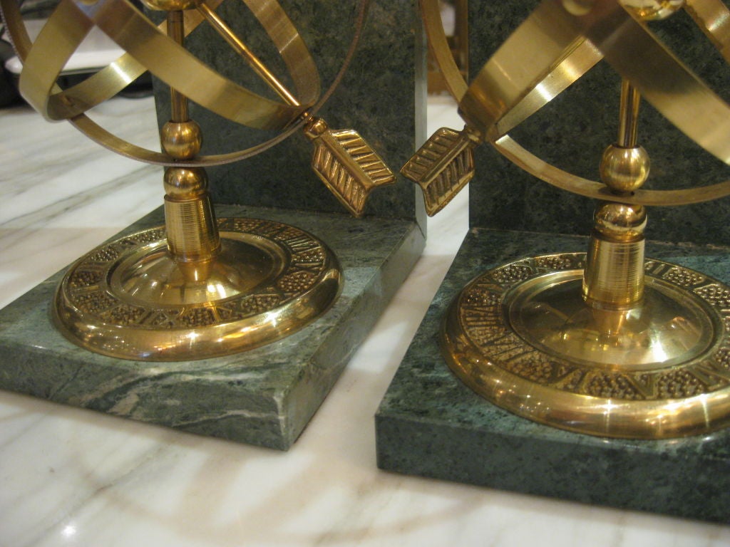 Unknown Pair of Brass Globe Arrow Bookends on Marble Slabs