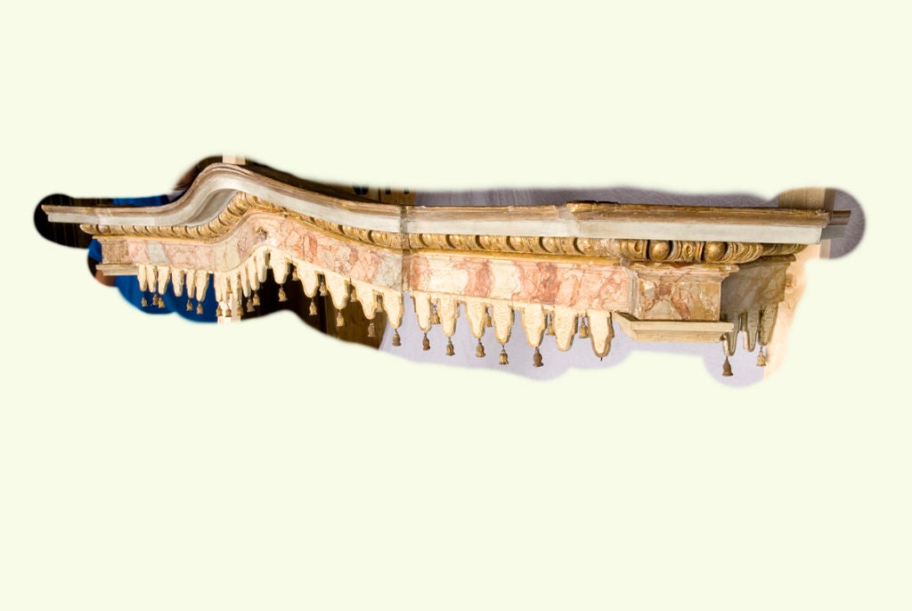 This beautiful polychrome and gilt-wood bed crown has wonderful sculpted detailing and small carved wood “tassels.” This Italian fantasy is from the late 18th or early 19th century. This bed crown is the perfect piece to make any bedroom, a fantasy