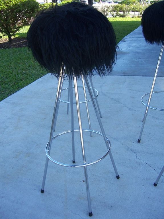 These cone shaped stools in polished steel are topped w/ beautiful long-hair Mongolian sheep's wool. Tres Chic!  Priced to sell!