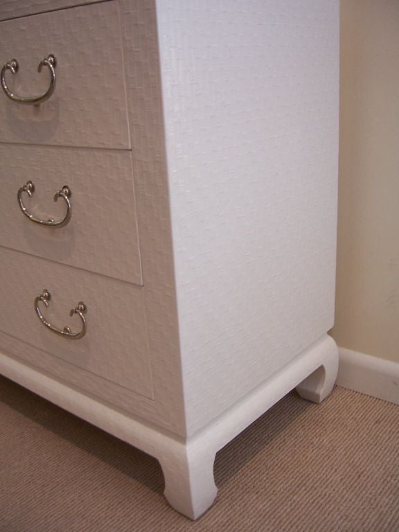 A White Lacquered Raffia Covered Double Commode by Baker