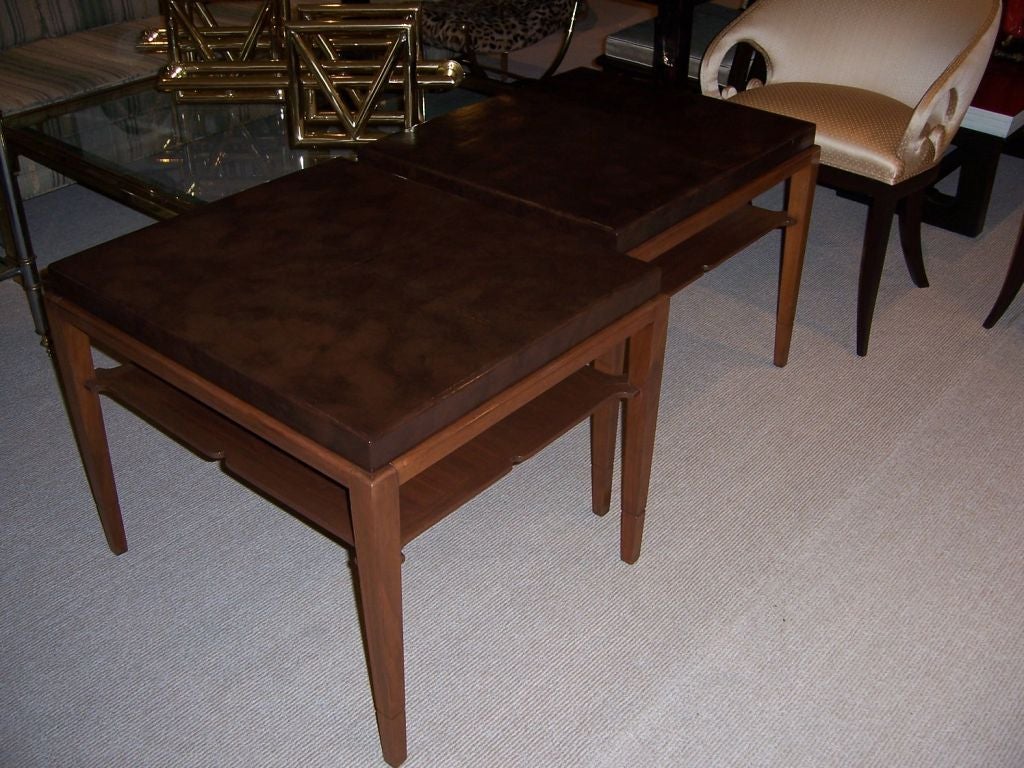 Simple and elegant two-tiered side tables with chocolate leather top on lightly stained oak bases.