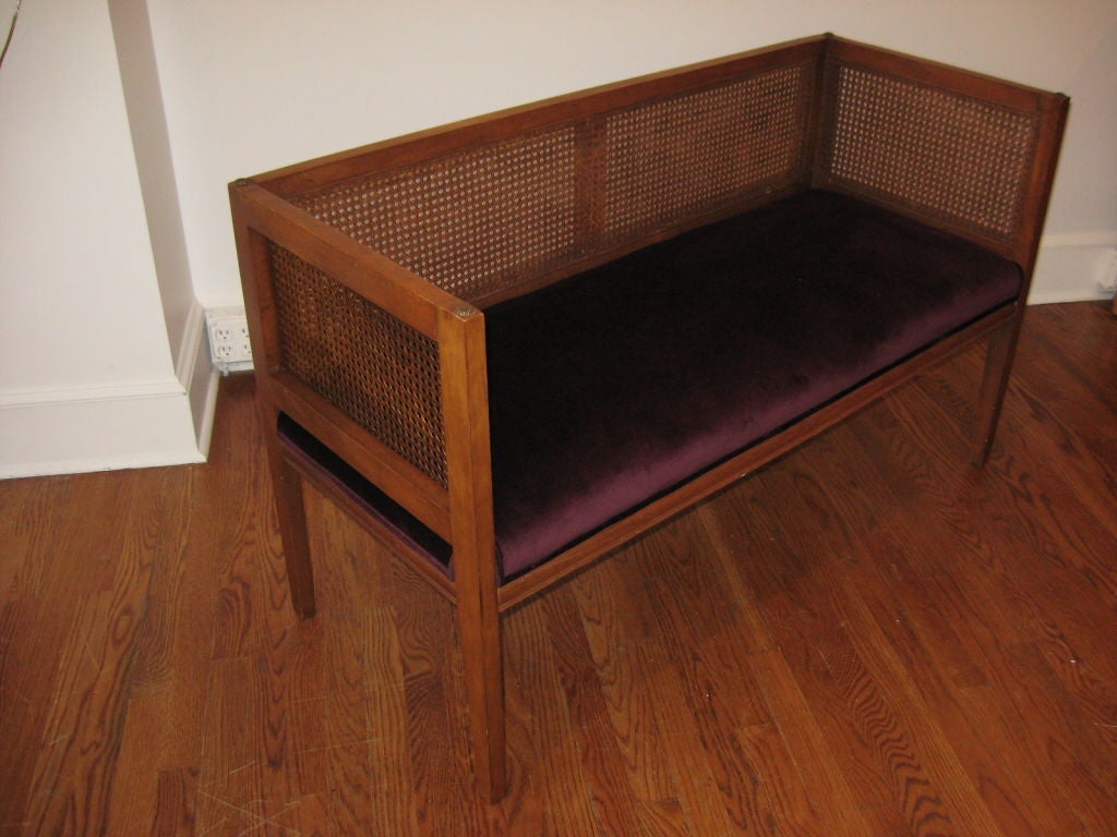 Bench with caned back and sides. Newly upholstered velvet seat.