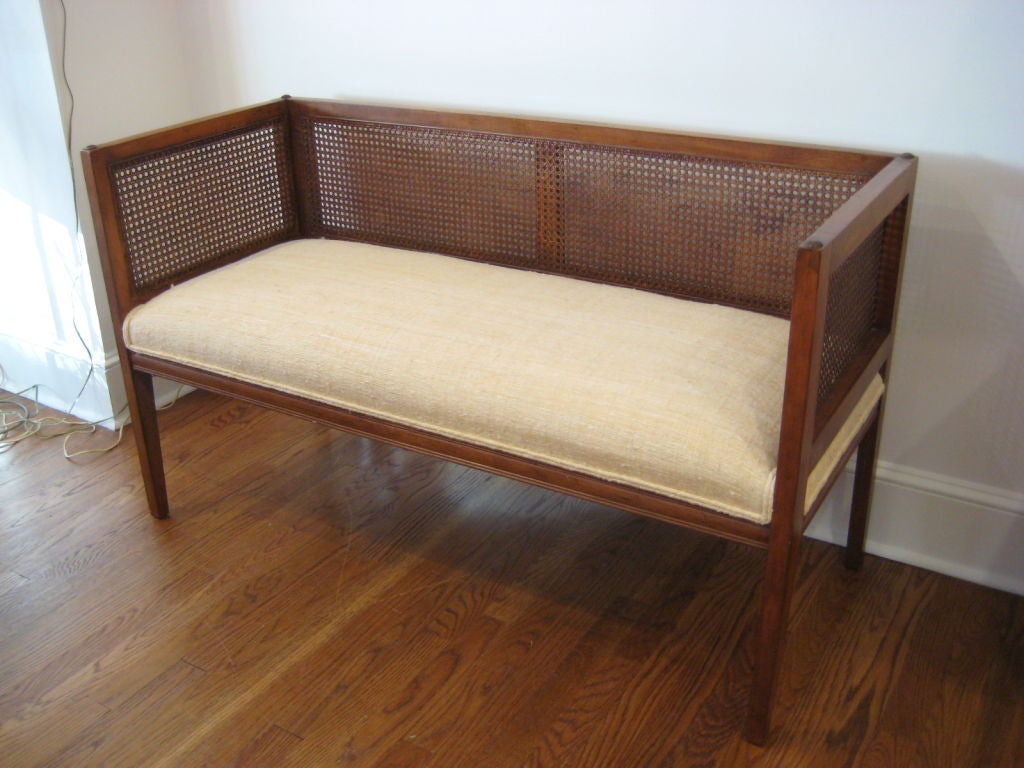Bench with caned back and sides.  Newly upholstered in silk fabric.