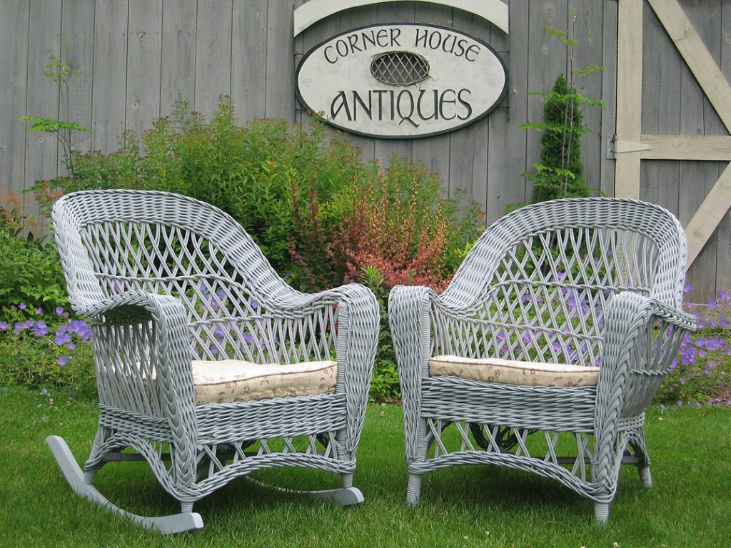 Unusual matching Bar Harbor style wicker pair - armchair and rocking chair painted light gray.  Double reeded diagonal latticing throughout. Gentle upward curve to arms with v-shaped taper to legs.  Magazine pocket woven into left arm of chair.