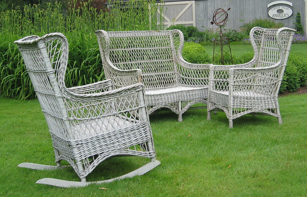 Three-piece Bar Harbor matching wicker set in worn white painted finish - can be re-painted any color on request. High backrests, wingback design in traditional open lattice weave. Braided arms, pineapple-twist feet on chair and settee. Woven seats.