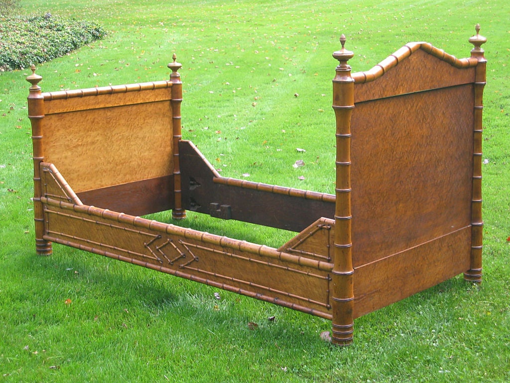 Rare American faux bamboo single bed attributed to R. J. Horner. Turned finials on the four corner posts, applied decorative bamboo mouldings to head and foot boards as well as bracketed siderails.  Birdseye maple with wonderfully aged patina. 
