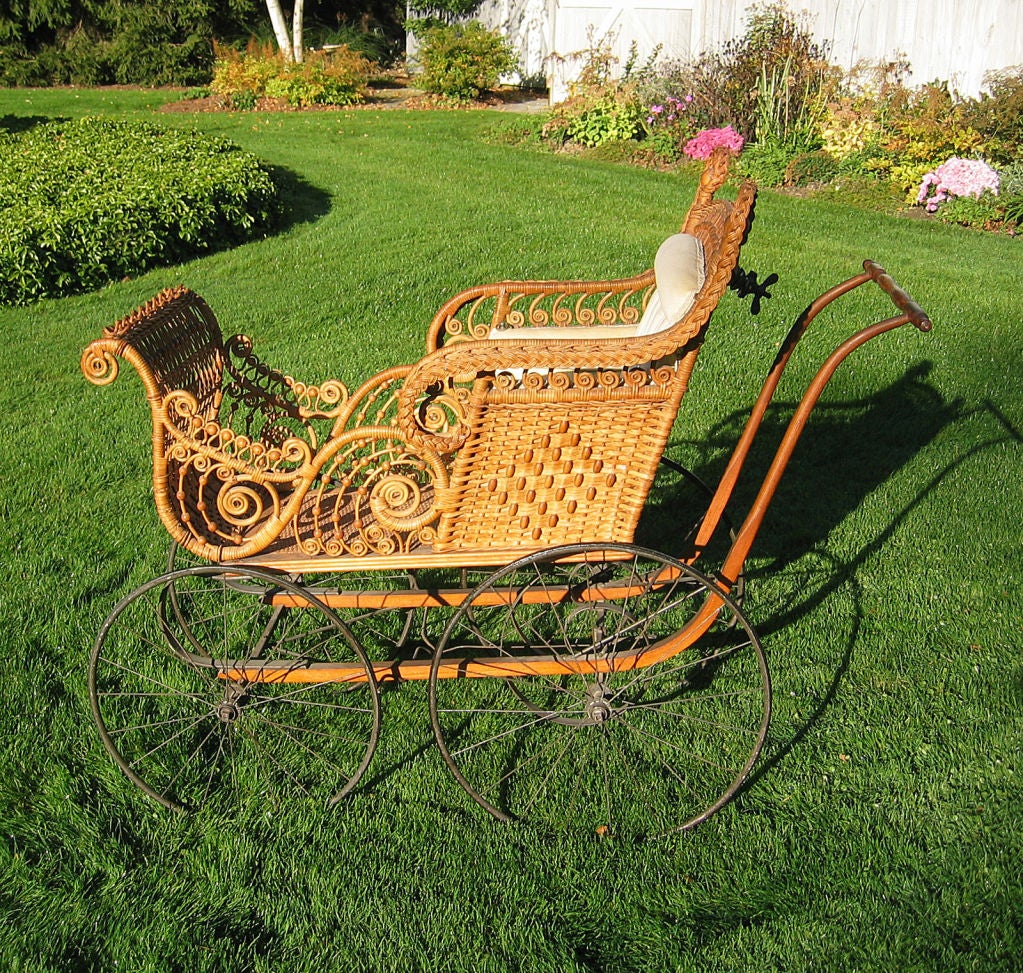 The elaborate ornamentation of this intricately woven<br />
carriage is representative of the Aesthetic Movement of the<br />
Victorian period. Multiple curlicues and criss-crossed reed<br />
latticing enhance the overall florid design.