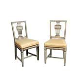 A Pair of Neoclassical Painted 
Parcel Gilt Chairs