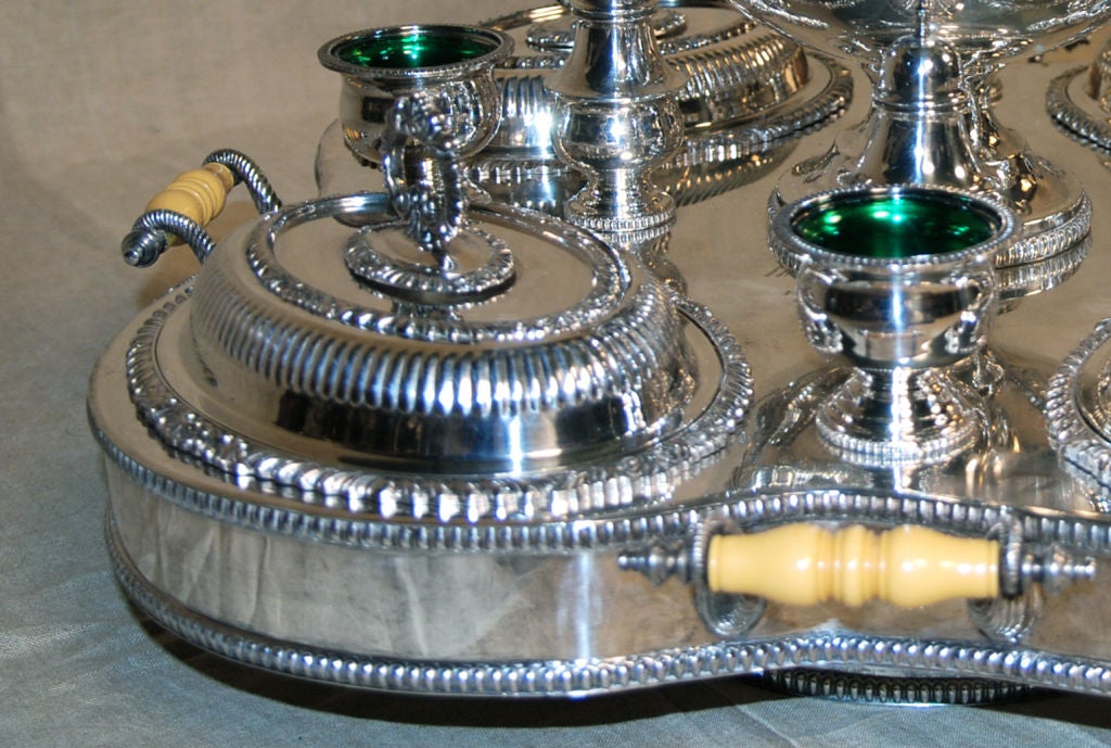 Marked with a Crown above a tree with animals<br />
<br />
Comprising a large tureen with ladle, with four serving dishes with covers, four small cups with glass inserts, and four salt and pepper shakers, all on a turntable base with hot water