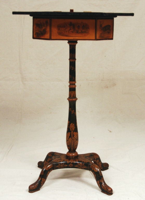 The stand decorated with painted panels and pen work, the hinged top with a painted panel opening to a compartment, on a pen work base with cabriole legs, on pad feet.