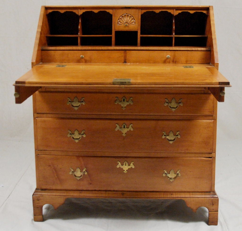 An American Chippendale <br />
Maple Slant Front Desk<br />
Rhode Island <br />
18th Century <br />
<br />
The slant front opens to reveal a fitted interior <br />
with a shelf form carving.  Over four graduating drawers with Chippendale