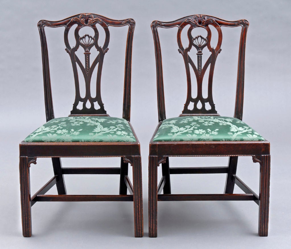 Pair of very fine Chippendale period mahogany side chairs with serpentine top rail, interlacing splats with pierced Prince of Wales plume and foliate designs, molded chamfered legs, beaded apron edge and H-shaped stretchers. Drop-in seats are