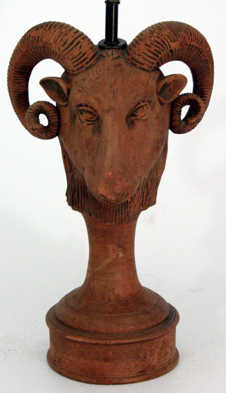 A fantastic figural terra cotta lamp in the form of a humanistic goat head.