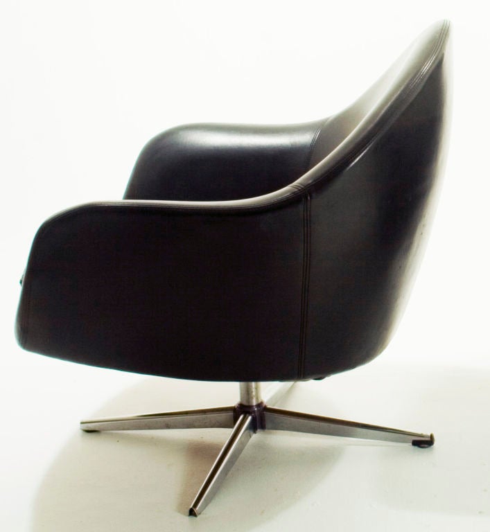 This pair of sculptural arm chairs feature original black vinyl upholstery over a polystyrene frame and swivel easily on their chrome-plated bases--characteristic of Swedish designer Carl Klote's mid-century designs for Knoxville, Tennessee-based