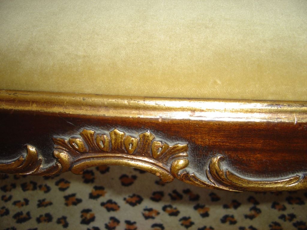 A lovely mahogany Louis XV style bench with apparently a lighter then darker stain applied on top, gilt details.  Fresh subtle gold cotton velvet cover.