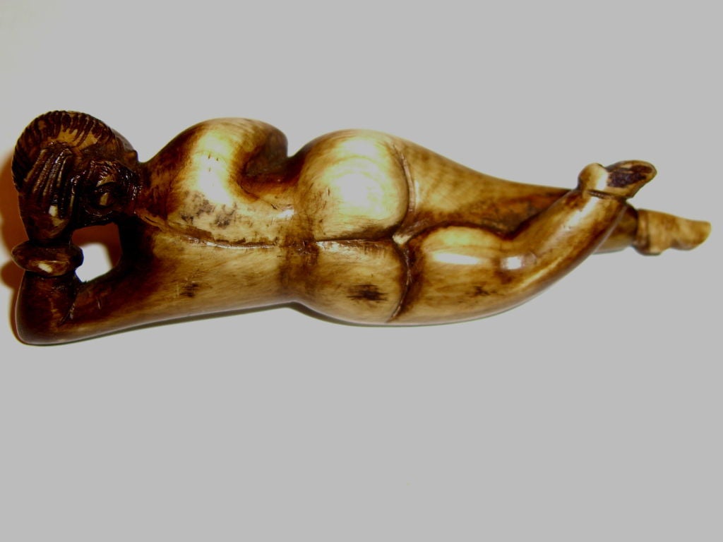 An extremely unusual and rare 19th century snuff box or container in the shape of a nude woman or medical model. One foot removes and contains a little spoon. The ivory is 19th century, the stand is newer made to hold it properly in place for