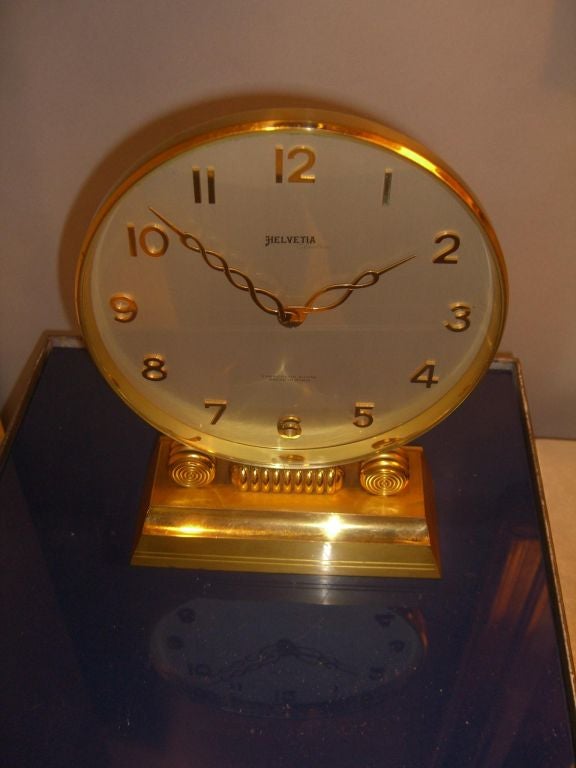 A somewhat rare and unique Electric Mechanical clock by the high quality firm of Helvetia of Switzerland. It uses a battery to power a traditional mechanical clock movement. It was developed at the same time as the famous Hamilton electric watches