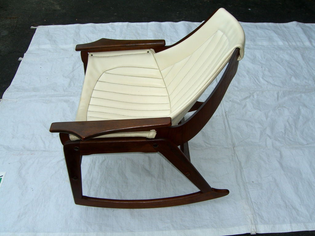 A nice rocker made of walnut with a sling seat. It bears a label of the Charlton co of Leominster Mass.