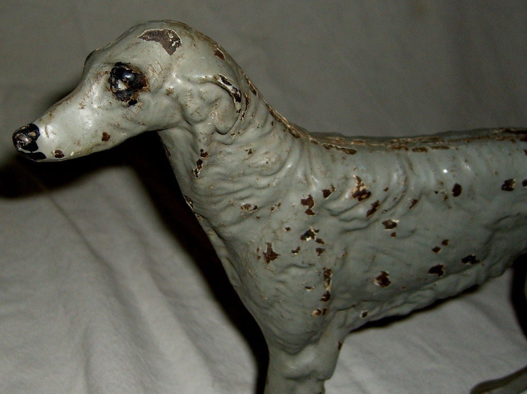 A great cast iron doorstop cast in the shape of a borzoi. This is a classic dog used in many art deco motifs and deigns, This whimsical doorstop is of the period and has most of it's original paint. It is a great piece of sculpture as well as a