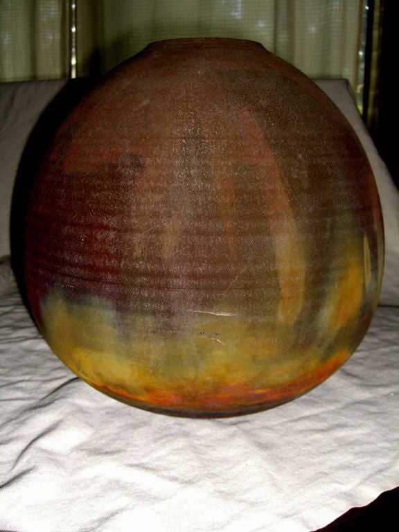 A beautifully fired raku vase the the noted Potter Russell Kagan. The vase is fired in the antique japanese raku way, a method first used in Japan in the 16th century. Mr. Kagan has interpreted this antique firing in his own way to produce a hand