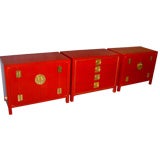 Three John Stuart chinoiserie styled red lacquered cabinets