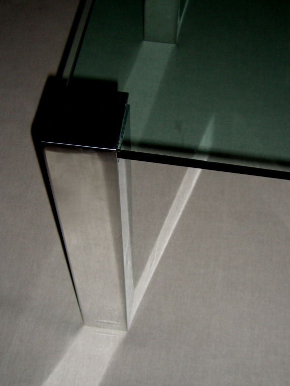 A nicely designed by Paul M Jones adjustable aluminum legged glass table. The legs feature an adjustable screw that tightens the leg onto the glass. You can use the legs for granite or marble if you choose as well.