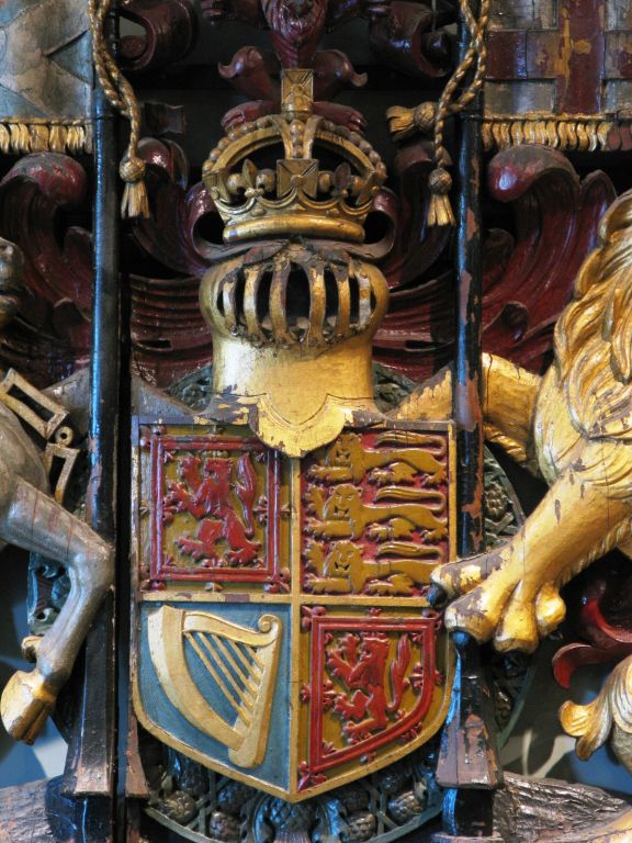 Royal Scottish Coat of Arms carved in wood. This coat of arms was generally displayed only at the pleasure of the ruler of Great Britain. It is solid wood with the correct heraldic paint colors.