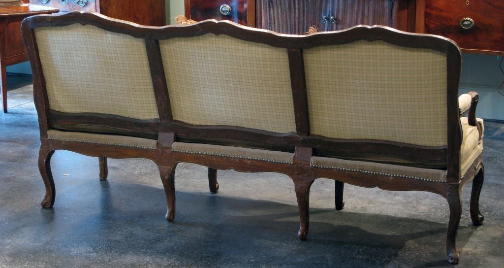 18th C Sofa in walnut. Original condition with restoration limited to updating the internal structure under the new upholstery.