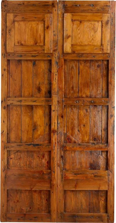 An 18th century antique Spanish double door with two windows and iron clavos<br />
*price subject to change based on conversion of 4,136 Euros. <br />
www.porteradoors.com