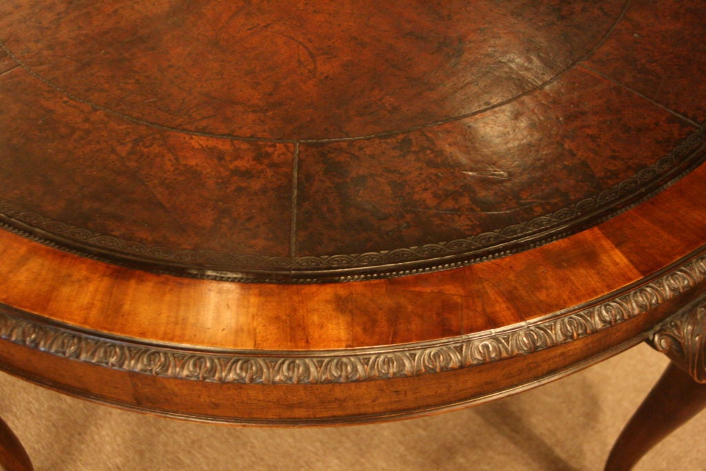 Exceptional round English mahogany Library/Center Table with dark drown hand tooled mottled leather surface. Wonderful patina. Chippendale style acanthus leaf knees with cabriole legs and ball and claw feet.  Gadrooned edge above 5ins Apron.  Diam