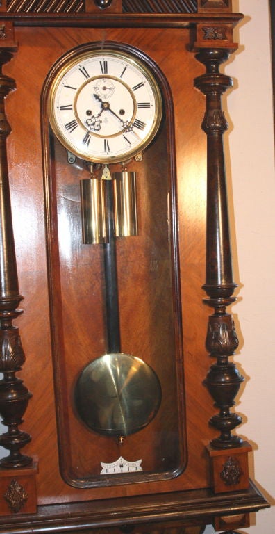 Fabulous walnut and satinwood Vienna regulator wall clock by Gustav Becker in good working condition.  Strikes on the hour and half hour.  2nd Hand.  Pediment with Spread Eagle and traditional carved classical face below.  Superb condition. White