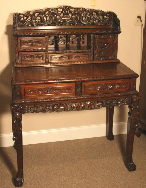 FANTASTIC Chinese Lignum Vitae (hardest wood)matching desk and chair set.   Exceptional Chinese carvings depiting dragons and foliate design.  Extremely heavy.   2 Desk drawers Back section with 3 drawers, cupboard and pigeon holes. Superb patina.