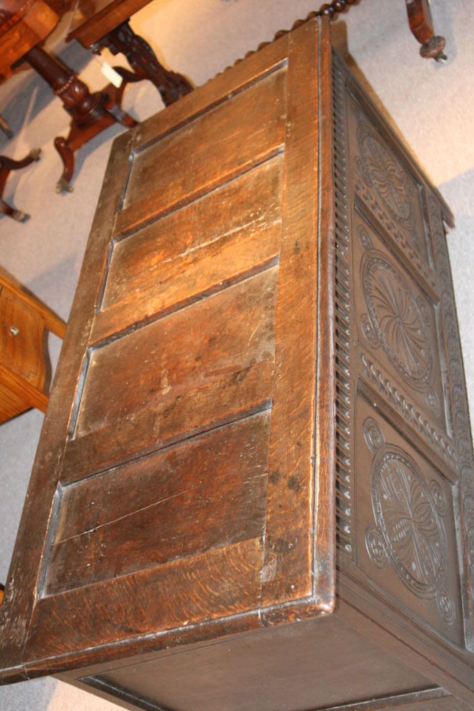 Excellent English oak carved 18th century coffer.  Panelled on all sides, carved on the front.   All joints have been pegged (no screws).  Designed for a wall situation since the back is unpolished wood.   Great patina.   Lock is not operational.
