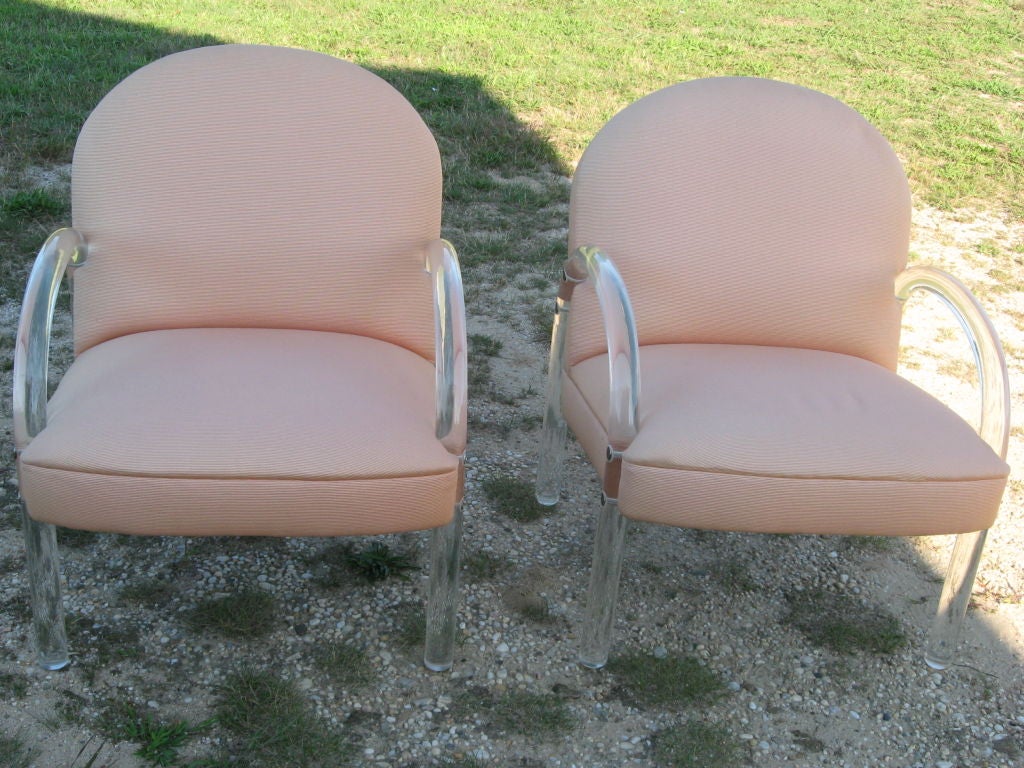 Pair of Lucite lounge chairs by Pace Collection with peach upholstery, Hampton location.