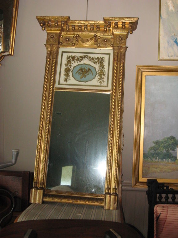 Regency giltwood pier mirror with églomisé eagle decoration.