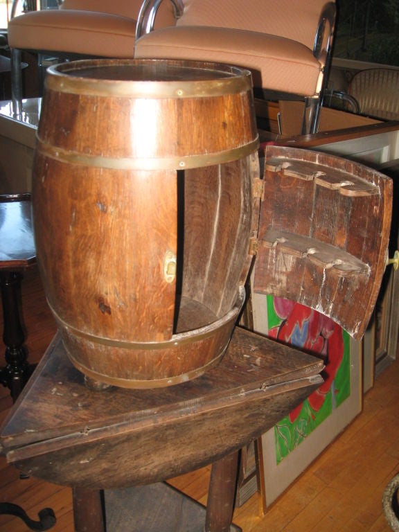 Handmade oak and brass smoking table that has a pipe rack on door.