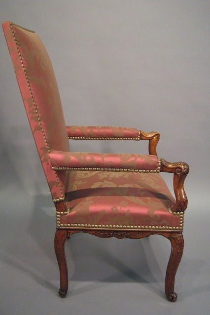 A fine Regence period Fauteuil in Walnut, dating from the first quarter of the 1700s, and French in origin. The high-back design resting atop four cabriole legs, each with graceful form and carved Rocaille designs. <br />
<br />
The seat and back