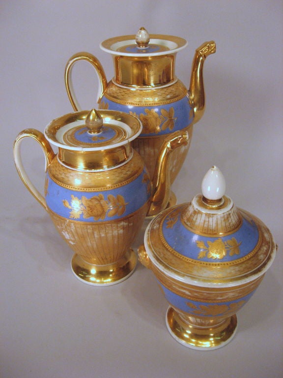 A good Paris porcelain tea and coffee service, comprising a Teapot, Coffeepot, & Sucrier. The service dating from the second quarter of the 1800s, and French in origin. <br />
<br />
Each body and cover decorated with bands of blue-ground