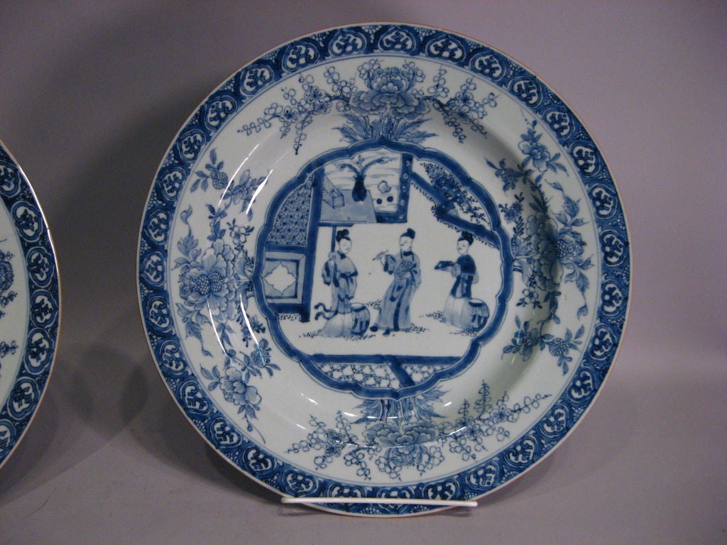 A fine pair of Kangxi period (1662-1722) Chargers with excellent underglaze blue decoration, and each of impressive size. <br />
<br />
Each plate features an intricate border with floral sprays in an open field. The central vignette, reserved by
