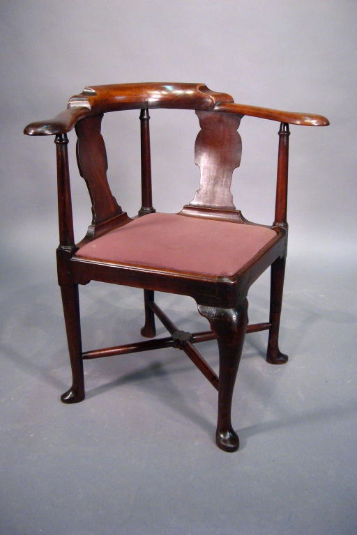 A fine George II period Corner Chair, constructed in solid Red Walnut with Turned Columns & lift-out seat. English in origin, dating from the mid-1700s. 

The upholstered seat with exposed rail, resting atop three turned legs & 1 Cabriole leg