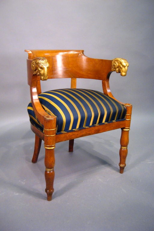 A fine Empire design Fauteuil de Bureau, constructed in Walnut with a richly-figured veneer & gilt accents throughout. Dating from the second quarter of the 1800s, and French in origin. <br />
<br />
The chair with rich gilt details, notably the