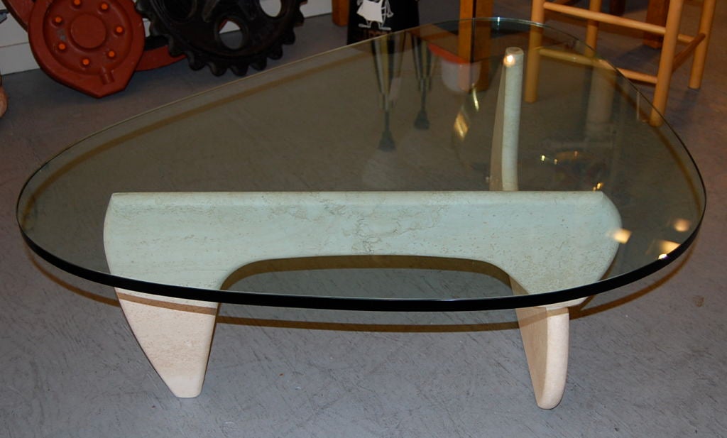 A curious example of the classic IN-50 coffee table design by Isamu Noguchi, not sure on the origin of this piece, in any case the base is a well executed and quality constructed travertine, having a similar form as the IN-50. An engaging coffee