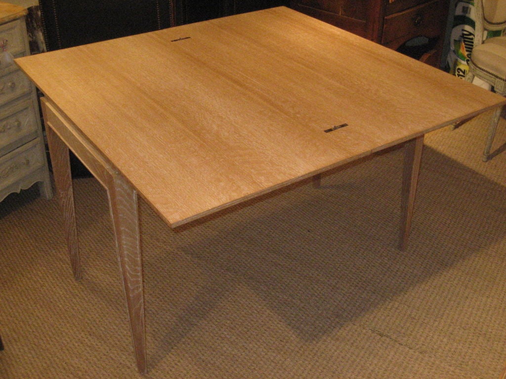 A French 1940's style “portfolio” table that opens to a square breakfast/card table, in cerused oak, custom made.